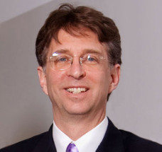Michael Warshauer, one of America's Top 50 Lawyers, wearing a suit and a purple tie
